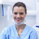 Smiling dental assistant in dental clinic